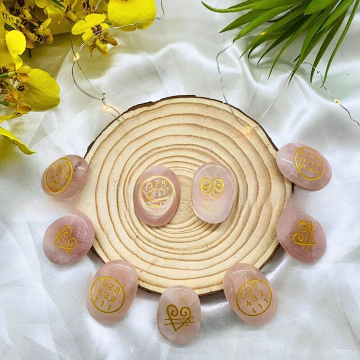 Close-up of Rose Quartz ZIBU Coins showing pink crystal and sacred ZIBU symbols for meditation and healing.
